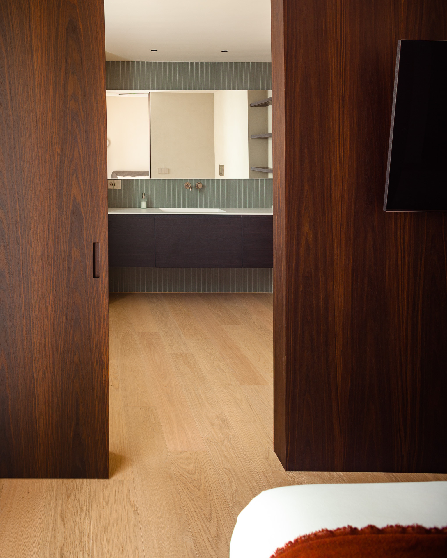 Walnut joinery in the master bedroom at Grimaldi Residence