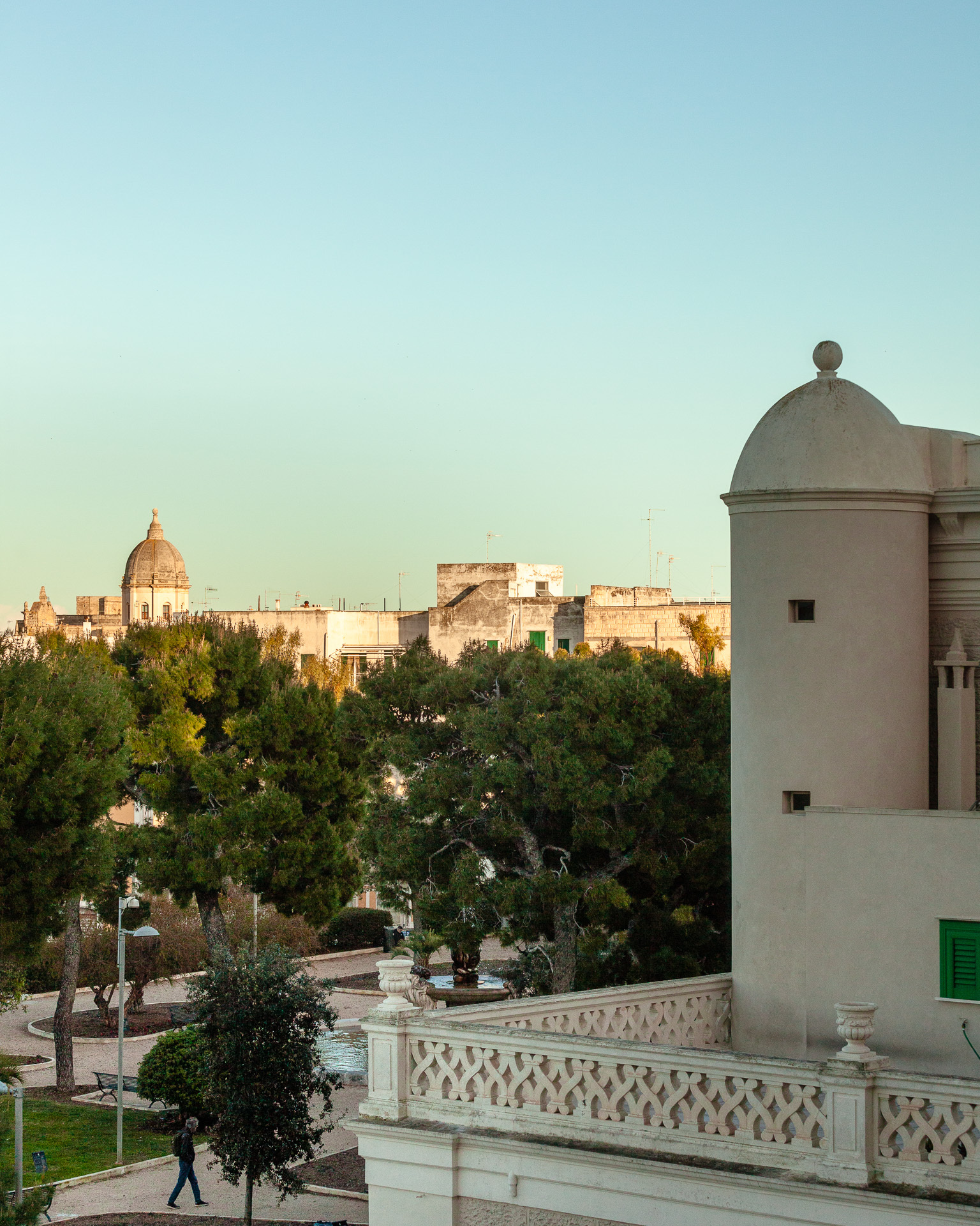 Monopoli seafront ramparts and the cathedral dome in late-afternoon light